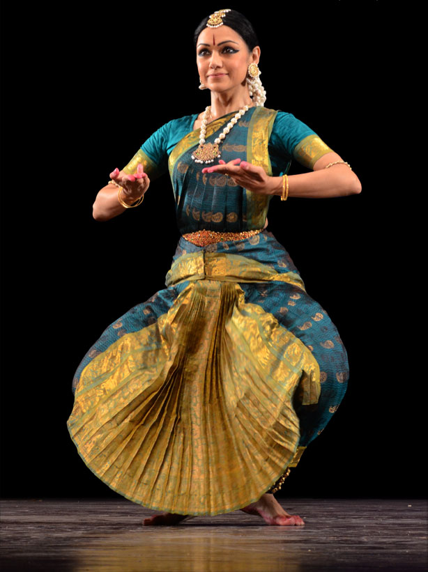 Rama Vaidyanathan in teal and gold Bharatanatyam costume, holding an expressive pose